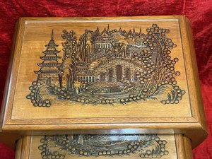 Oriental Teak Nest Of Four Tables With Mudiao Fretwork Temple Landscape Tops Circa - 1950 Composition - Teak Listing Description Set Of Four Elegant Oriental Rectangular Nesting Tables With Finely Carved Mudiao Fretwork Landscapes Under Protective Glass Tops. All Set Upon Sabre Legs With Support Stretchers. Each Table Diminishing In Size Has Oriental Village Scene With Ornate Native Trees, Elaborate Pagodas, Large Foot Bridge Over Water With Chinese Figures Crossing And Sampan Boat. Condition - Excellent Dimensions In Inches Largest Height 24.5" X Width 22" X Depth 13.5" Smallest Height 16.5" X Width13" X Depth 10.5"