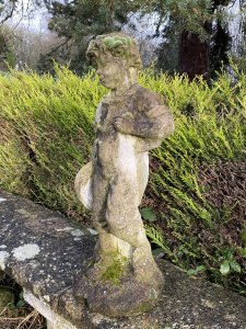 Country Estate Gardening Boy Holding Straw Bower Garden Sculpture. Composition- Reconstituted Stone Circa - Vintage Charming Young Gardening Boy With Handsome Face And Curled Hair Wears Collared Shirt, Dungarees And Lace Up Boots. Holding Straw Bower In His Hand. Beautiful Weathered Garden Centre Piece With Organic Foliage and Moss Clumps Organically Growing On The Statue. This Really Adds To The Charm Of The Piece. Beautiful Sculpture For Country Garden, Rockeries , Patio. Provenance Purchased From Scottish Country Manor And Now Part Of Historical Lord Hill Museum Private Collection. Dimensions In Inches Height 28” Width 12 Base Width 10 X Depth 9