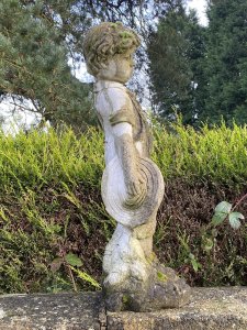 Country Estate Gardening Boy Holding Straw Bower Garden Sculpture. Composition- Reconstituted Stone Circa - Vintage Charming Young Gardening Boy With Handsome Face And Curled Hair Wears Collared Shirt, Dungarees And Lace Up Boots. Holding Straw Bower In His Hand. Beautiful Weathered Garden Centre Piece With Organic Foliage and Moss Clumps Organically Growing On The Statue. This Really Adds To The Charm Of The Piece. Beautiful Sculpture For Country Garden, Rockeries , Patio. Provenance Purchased From Scottish Country Manor And Now Part Of Historical Lord Hill Museum Private Collection. Dimensions In Inches Height 28” Width 12 Base Width 10 X Depth 9