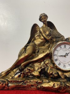 Classical Athena Goddess Of Wisdom Ornate Gilded Mantle Clock W M Widdop Movement Circa - Vintage Composition - Resin Listing Description Ornate Mythological Decorative Mantle Clock Depicting Half Nubile Winged Goddess Of Wisdom And War Athena. Beautifully Posed Female Sitting Perched On A Rock Cluster Holding The Aegis Shield. Stunning Details Of Facial Features, Delicate Hands And Feet With Large Angel Wings In Textural Feathers. Hand Crafted Piece In Resin With Antiqued Guilt Work Finish . Internal W M Widdop Est 1883 Quartz Japanese Movement With Battery Power Source, Requires One AA Battery. Dimensions In Inches Height 40cm Width 46cm Depth 16cm