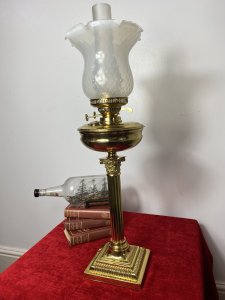 Brass Corinthian Column Table Oil Lamp With White Opaque Glass Funnel & Shade. Beautiful Decorative Brass Corinthian Table Lamp Stand With Oil Lamp Top And Rare Opaque Bristol Glass Funnel And Bell Shaped Shade. Beautifully Restored With Oil Vessel Tank And Wick In Exceptional Condition. Perfect Working Order. Handsome Design Made Originally In Pall Mall London By Quality Manufacturer. Dimensions In Inches Height 29” Base Width Square 6 3/4” Weight Approx 15KG