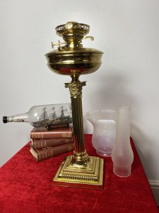 Brass Corinthian Column Table Oil Lamp With White Opaque Glass Funnel & Shade. Beautiful Decorative Brass Corinthian Table Lamp Stand With Oil Lamp Top And Rare Opaque Bristol Glass Funnel And Bell Shaped Shade. Beautifully Restored With Oil Vessel Tank And Wick In Exceptional Condition. Perfect Working Order. Handsome Design Made Originally In Pall Mall London By Quality Manufacturer. Dimensions In Inches Height 29” Base Width Square 6 3/4” Weight Approx 15KG