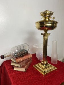 Brass Corinthian Column Table Oil Lamp With White Opaque Glass Funnel & Shade. Beautiful Decorative Brass Corinthian Table Lamp Stand With Oil Lamp Top And Rare Opaque Bristol Glass Funnel And Bell Shaped Shade. Beautifully Restored With Oil Vessel Tank And Wick In Exceptional Condition. Perfect Working Order. Handsome Design Made Originally In Pall Mall London By Quality Manufacturer. Dimensions In Inches Height 29” Base Width Square 6 3/4” Weight Approx 15KG