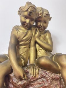 French Art Nouveau Gilt Children Upon Rock With Sailboat Rouge Marbled Sculpture Circa - 1920's Composition - Over Glazed Earthenware Large Museum Quality Sculpture Depicting Two Young Boys Perched Together Upon A Red Dripglaze Marbled Rock. Both Looking Down At Toy Sailboat In The Water. Fine Detail Of Cherabesent Childern With Defined Smiling Faces, Detailed Hands And Feet. Wonderful Artwork Captures The Mood & Movement In The Clothing And Water. Beautiful Quality & Charming Subject Displaying Brass Title Plaque Reading FUTURS MARINS. Condition - Original Antique Used Showing Signs Of Wear Conducive To Age. Provenance Purchased From Paris Collector Dimensions In Inches Height 19" Width 13" Base 10" X 7"