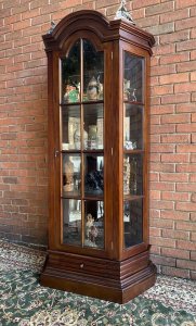 Fine Georgian Style Berger Master Tall Curved Diaplay Cabinet In Solid Elm Wood. Solid Elm Wood Crafted Tall Display Cabinet With Domed Top, Bevelled Glass Panelled Door And Concave Bevelled Glass Side Panels. Bronze Handles. Four Interior Solid Elm Shelves With Mirrored Back For Stunning For Display Of Fine Silver/ Antiques Collection. Beautiful Architectural Stepped Base With Front Pull Out Drawer. Heavy Craftsman Made Piece. Dimensions In Inches Height 77” Width 35” Depth 18” Between Shelf Depth 13