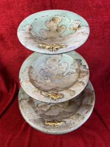 Vintage Mesa Verde Style Hand Painted 3 Tier Fruit Stand With Lizard Motifs. Circa - Vintage Composition- Earthenware / Pottery Colour Way - Blue, Teal, Gold Stunning Three Tier Metal Stand With Elegant Tripod Legs. Complete With Three Diminishing Bowls Hand Painted With Abstract Canyon Style Landscape With Ornate Gilt Lizard Motif On Each Bowl Edge. Exceptionally Decorative Piece For Fruit / Bon Bons Or Floral Display. Strong Mesa Verde National Park Tribal Influence. Dimensions In Inches Height 22” Top Bowl Diam 8” Medium Bowl Diam 11.5” Bottom Bowl 15 3/4”