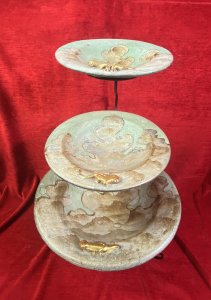 Vintage Mesa Verde Style Hand Painted 3 Tier Fruit Stand With Lizard Motifs. Circa - Vintage Composition- Earthenware / Pottery Colour Way - Blue, Teal, Gold Stunning Three Tier Metal Stand With Elegant Tripod Legs. Complete With Three Diminishing Bowls Hand Painted With Abstract Canyon Style Landscape With Ornate Gilt Lizard Motif On Each Bowl Edge. Exceptionally Decorative Piece For Fruit / Bon Bons Or Floral Display. Strong Mesa Verde National Park Tribal Influence. Dimensions In Inches Height 22” Top Bowl Diam 8” Medium Bowl Diam 11.5” Bottom Bowl 15 3/4”