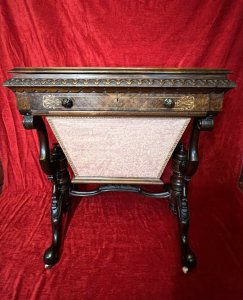 Victorian C1860 Museum Quality Burl Walnut And Marquetry Inlaid Sewing Table Circa - Period Victorian 1860 Composition - Burl Walnut With Satinwood Listing Description Finest Quality Period Victorian Antique Sewing Table/Cabinet. Elegant Burl Walnut Cabinet With Fine Floral Marquetry Inlay, Top Lid Lifts Up Revelling Red Leather Work Top With Opening Satinwood Storage & Various Compartments Surrounding For Sewing Equipment. Decorative Gladrooned Table Edge Protrudes, Underneath A Satinwood Cased Pull Out Drawer With Matching Hand Carved Balloon Shaped Handles, Containing Pin Cushions And Storage For Beads, Threads, Spools And Trinkets. Large Bottom Tier Is Pull Out Fabric/ Wool Store With Original Silk Lined Interior And Exterior. The Cabinet Stands Upon Mirrored Lyre Shaped Scroll Legs With Central Pinnacle & Looped Stretcher All Decorated With Feminine Folate Carving. Castor Wheels For Ease Of Movement. Condition - Excellent Minor Scuffs, Scratches And Usage Marks Due To Period Age Overall Condition Is Excellent. For More Information Please Call 07376 618513 Thank-you Dimensions In Inches Height 28.5" Width 24" Depth 18.5"