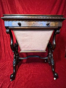 Victorian C1860 Museum Quality Burl Walnut And Marquetry Inlaid Sewing Table Circa - Period Victorian 1860 Composition - Burl Walnut With Satinwood Listing Description Finest Quality Period Victorian Antique Sewing Table/Cabinet. Elegant Burl Walnut Cabinet With Fine Floral Marquetry Inlay, Top Lid Lifts Up Revelling Red Leather Work Top With Opening Satinwood Storage & Various Compartments Surrounding For Sewing Equipment. Decorative Gladrooned Table Edge Protrudes, Underneath A Satinwood Cased Pull Out Drawer With Matching Hand Carved Balloon Shaped Handles, Containing Pin Cushions And Storage For Beads, Threads, Spools And Trinkets. Large Bottom Tier Is Pull Out Fabric/ Wool Store With Original Silk Lined Interior And Exterior. The Cabinet Stands Upon Mirrored Lyre Shaped Scroll Legs With Central Pinnacle & Looped Stretcher All Decorated With Feminine Folate Carving. Castor Wheels For Ease Of Movement. Condition - Excellent Minor Scuffs, Scratches And Usage Marks Due To Period Age Overall Condition Is Excellent. For More Information Please Call 07376 618513 Thank-you Dimensions In Inches Height 28.5" Width 24" Depth 18.5"