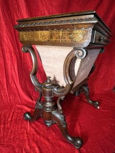 Victorian C1860 Museum Quality Burl Walnut And Marquetry Inlaid Sewing Table Circa - Period Victorian 1860 Composition - Burl Walnut With Satinwood Listing Description Finest Quality Period Victorian Antique Sewing Table/Cabinet. Elegant Burl Walnut Cabinet With Fine Floral Marquetry Inlay, Top Lid Lifts Up Revelling Red Leather Work Top With Opening Satinwood Storage & Various Compartments Surrounding For Sewing Equipment. Decorative Gladrooned Table Edge Protrudes, Underneath A Satinwood Cased Pull Out Drawer With Matching Hand Carved Balloon Shaped Handles, Containing Pin Cushions And Storage For Beads, Threads, Spools And Trinkets. Large Bottom Tier Is Pull Out Fabric/ Wool Store With Original Silk Lined Interior And Exterior. The Cabinet Stands Upon Mirrored Lyre Shaped Scroll Legs With Central Pinnacle & Looped Stretcher All Decorated With Feminine Folate Carving. Castor Wheels For Ease Of Movement. Condition - Excellent Minor Scuffs, Scratches And Usage Marks Due To Period Age Overall Condition Is Excellent. For More Information Please Call 07376 618513 Thank-you Dimensions In Inches Height 28.5" Width 24" Depth 18.5"