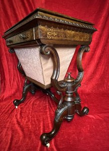 Victorian C1860 Museum Quality Burl Walnut And Marquetry Inlaid Sewing Table Circa - Period Victorian 1860 Composition - Burl Walnut With Satinwood Listing Description Finest Quality Period Victorian Antique Sewing Table/Cabinet. Elegant Burl Walnut Cabinet With Fine Floral Marquetry Inlay, Top Lid Lifts Up Revelling Red Leather Work Top With Opening Satinwood Storage & Various Compartments Surrounding For Sewing Equipment. Decorative Gladrooned Table Edge Protrudes, Underneath A Satinwood Cased Pull Out Drawer With Matching Hand Carved Balloon Shaped Handles, Containing Pin Cushions And Storage For Beads, Threads, Spools And Trinkets. Large Bottom Tier Is Pull Out Fabric/ Wool Store With Original Silk Lined Interior And Exterior. The Cabinet Stands Upon Mirrored Lyre Shaped Scroll Legs With Central Pinnacle & Looped Stretcher All Decorated With Feminine Folate Carving. Castor Wheels For Ease Of Movement. Condition - Excellent Minor Scuffs, Scratches And Usage Marks Due To Period Age Overall Condition Is Excellent. For More Information Please Call 07376 618513 Thank-you Dimensions In Inches Height 28.5" Width 24" Depth 18.5"