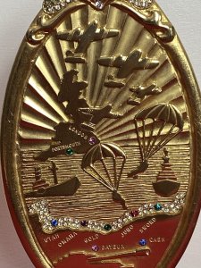 50 Year Commemorative Gold Plated Plaque Celebrating Second World War D Day Circa - 1994 Composition - Gold Plated Metal Elaborate Oval Gold Plated Plaque On Stand To Commemorate The Largest Sea Borne Invasion In History Embossed With Sea View With British Isles Outline, War Planes, Soldiers Parachuting And Fighter Bombers/Ships With Large Tank. Showing All Landmarks Of The War And Encrusted With Semi Precious Stones. Winston Churchill Quote In Tribute To The Bomber And Air Crews For They're Enormous Efforts To Establish Air Superiority Over England. ' NEVER IN THE FIELD OF HUMAN CONFLICT WAS SO MUCH OWED BY SO MANY TO SO FEW' Stamped On The Back Sterling Mint London. Provenance Purchased Directly From War Veteran, London. Dimensions In Inches Height 8" Base 3" Diameter