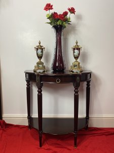 Vintage Regency Style Cherry Mahogany Demi-Lune Occasional Hall Table Circa - Vintage Composition - MDF Shell Overlaid With Cherry Mahogany Veneer Vintage Cherry Mahogany Demi Lune Occasional Hall Table In The Regency Style With Semi Circle Top And Pull Out Drawer With Brass Garland Handle For Storage Of Paperwork. Stands Upon Four Elegant Legs With Decorative Brass Floral Plaque Ornamentation With Brass Floor Mounts And Under Shelf For Ornament Display. Condition - Very Good Original A Couple Of Scratches To Top And One Of The Brass Foot Mounts Missing On Front Leg (Left Side). Please See Listing Images Dimensions In Inches Height 30" Width 31" Depth 15" Drawer Depth 2"