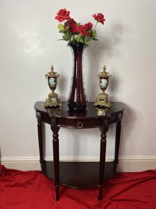 Vintage Regency Style Cherry Mahogany Demi-Lune Occasional Hall Table Circa - Vintage Composition - MDF Shell Overlaid With Cherry Mahogany Veneer Vintage Cherry Mahogany Demi Lune Occasional Hall Table In The Regency Style With Semi Circle Top And Pull Out Drawer With Brass Garland Handle For Storage Of Paperwork. Stands Upon Four Elegant Legs With Decorative Brass Floral Plaque Ornamentation With Brass Floor Mounts And Under Shelf For Ornament Display. Condition - Very Good Original A Couple Of Scratches To Top And One Of The Brass Foot Mounts Missing On Front Leg (Left Side). Please See Listing Images Dimensions In Inches Height 30" Width 31" Depth 15" Drawer Depth 2"