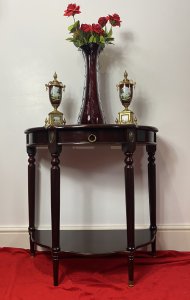 Vintage Regency Style Cherry Mahogany Demi-Lune Occasional Hall Table Circa - Vintage Composition - MDF Shell Overlaid With Cherry Mahogany Veneer Vintage Cherry Mahogany Demi Lune Occasional Hall Table In The Regency Style With Semi Circle Top And Pull Out Drawer With Brass Garland Handle For Storage Of Paperwork. Stands Upon Four Elegant Legs With Decorative Brass Floral Plaque Ornamentation With Brass Floor Mounts And Under Shelf For Ornament Display. Condition - Very Good Original A Couple Of Scratches To Top And One Of The Brass Foot Mounts Missing On Front Leg (Left Side). Please See Listing Images Dimensions In Inches Height 30" Width 31" Depth 15" Drawer Depth 2"
