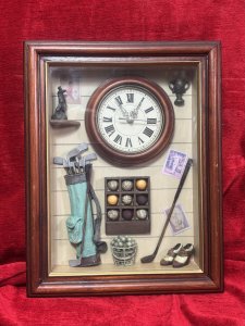 Golfing Enthusiasts Shadow Box/Diorama With Timepiece Circa - Vintage Composition - Wood, Glass, Resin, Mixed Media Listing Description Wonderfully Charming Shadow Box Of Golfing Enthusiasts Cloak Room. Complete With Panelled Wall Decor With Golfing Posters. Central Working (Battery Powered) Timepiece With Mahogany Frame. Corner Shelf With Golfing Statue & Wall Mounted Golfing Trophy. Golf Caddy Bag Complete With Clubs, Golf Ball Display Cabinet And Ball Bucket. As Well As Vintage Leather Style Golfing Shoes. Stunning Piece For Golfing Enthusiast, Man Cave, Library, Study, Hallway Wall Display. Dimensions In Cms Height 41cm X 31.5cm Width X Depth 6cm For Further Information Please Call The Museum Curator Leslie On 07707 488566 Thank-you.
