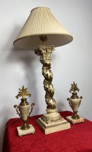 Italian Gilt Foliate Corinthian Column Table Lamp With Decorative Cream Shade. Large Deep Empire Style Shade With Ruched Pleated Fabric And Decorative Gimp Braided Edge Sits Upon Tall Barley Twist Corinthian Column Pillar With Heavy Gilt Folate Work Decoration. Stands On Square Base. Interior Designers Piece Beautiful For Hallway Or Room Centre Piece. Lamp In Perfect Working Order. UK Plug Fitting. Colour - Cream & Gold Base Composition - Resin Condition - Vintage Used Dimensions In Inches Total Height 32.5” Stand Height To Fitting 21 1/4” Base Width 6 3/4” X 7”