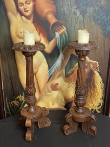 19th Century Large Pair Of Gothic Carved Walnut Tripod Candle Stands. Circa - 1865 Composition- Solid Walnut Condition- Lovely Used A Pair Of Solid Walnut Hand Carved Candles Stands With Shell Top Housing For Large Wax Candle With Decorative Pillar Enriched In Acanthus Leaf Motifs, Standing Upon Solid Tripod Plinth Bases. Beautiful Addition To Gothic Manor. Lovely For Next To An Elaborate Fireplace, Hallway Or Dining Area. Although These Are Being Sold As A Pair They Both Varies Slightly In Design. Please See Images Before Purchase. Provenance Purchased From Country Manor In The Scottish Highlands. Now Part Of Lord Hill Museum Private Collection. Dimensions In Inches Height 29.5” Top Housing Width 9” Tripod Base Width 10”