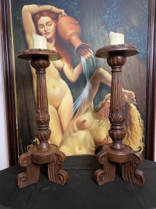 19th Century Large Pair Of Gothic Carved Walnut Tripod Candle Stands. Circa - 1865 Composition- Solid Walnut Condition- Lovely Used A Pair Of Solid Walnut Hand Carved Candles Stands With Shell Top Housing For Large Wax Candle With Decorative Pillar Enriched In Acanthus Leaf Motifs, Standing Upon Solid Tripod Plinth Bases. Beautiful Addition To Gothic Manor. Lovely For Next To An Elaborate Fireplace, Hallway Or Dining Area. Although These Are Being Sold As A Pair They Both Varies Slightly In Design. Please See Images Before Purchase. Provenance Purchased From Country Manor In The Scottish Highlands. Now Part Of Lord Hill Museum Private Collection. Dimensions In Inches Height 29.5” Top Housing Width 9” Tripod Base Width 10”