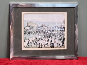 L S Lowry 'The Fairground 1949' Framed Lithograph Print Circa - 1950-1959 Composition - Printed Lithograph On Vellum Brief Artist History Laurence Stephen Lowry 1887-1976 Born into a middle class family and raised in the leafy outskirts of Manchester. Lowrys famous for painting scenes of life in in industrial districts of the North West Of England, where he lived and worked for more than 40 years. He developed a distinctive style of Nieve painting and is best known for his urban landscapes with multiple figures referred to as "Matchstick men". Lowry was never a full time artist. In his early 20's he took a job as a rent collector, and this would be his primary trade for four decades. Although Lowry painted most days after work, Often late into the night, and firmly rejected the term 'Sunday Painter' Remarking 'I'm a Sunday painter that paints every day of the week!" Lowry never adopted a impressionist colour palette and claimed to use five colours vermillion, ivory black, Prussian blue, yellow ochre and flake white. A large collection of Lowrys artworks are on permanent display in 'The Lowry Art Gallery' Salford Quays, named in his honour. Listing Description Original Lithograph of L S Lowry Titled 'The Fairground 1949' Showcasing A Exciting View Of The Fun Fair With Bright Iconic Stalls With Big Top Roofs. A Gathering Of Stalls Of Various Shapes And Sizes Set Amongst A Backdrop Of Blurred Grey Hills With The Shadow Of Factory Buildings. Huge Crowd With Hundreds Of Figures In An Array Of Poses Relevant to The Fairground Celebration. Wonderful Composition By Exceptional British Artist L S LOWRY. A Lithograph Print On Vellum Set Inside Original Glazed Chrome Frame. Dimensions In Inches Height 10.5" X Width 12 3/4" For Further information Please Call 07707488566 Thank-you