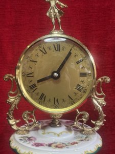 Capodimonte Porcelain Clock Rich Floral Bouquet And Ormolu Filigree Decoration Circa - Late 20th Century 1970's Composition - Porcelain / Metal Ormolu Filagree Listing Description Fine Quality Decorative Capodimonte Clock With Rococo Influence. Gilt Circular Clock Face With Filigree Binding & Roman Numerals And Minute Markings. Decorative Aristocratic Figure Pinnacle. Acanthus Leaf Scroll Mounts Suspend The Face And Are Set Onto Porcelain Body Decorated With Rich Floral Bouquets And Rich Green Paint Work. Front Opening Revealing Brass Rotating Clock Movement. Set On Darted Gilt Base With Decorative Green Man Feet. Battery Operated Movement. Dimensions In Cms Height x Width x Depth For Further Information Kindly Contact Via Telephone 07707488566 Thank-you