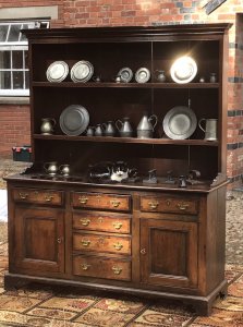 18th Century Oak Lancashire Dresser Cross Banded In Mahogany 6 Drawers With 2 Deep Cupboards With Internal Shelf On Bracket Pine Lined Drawers With Brass Drop Handles Shaped Feet Thick Original Oak Back Boards The Handles Have Been Replace Around 1980’s Please Note There Are Signs Of Shrinkage To The Top And Side Conducive To Age Charming Antique Investment For Country House Or Manor To Be Sold Complete With Collection Of Pewter Flagons Tankards And Hall Marked Plates Plus 6 Flt Irons With Interesting Brand Name Of The Period This Fine Dresser Came From A Manor House Near Lancashire Complete With 31 Object Pewter Collection Dimensions In Inches Top Height 42” Width 63” Base Height 33” Width 62” Depth 20”