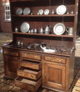 18th Century Oak Lancashire Dresser Cross Banded In Mahogany 6 Drawers With 2 Deep Cupboards With Internal Shelf On Bracket Pine Lined Drawers With Brass Drop Handles Shaped Feet Thick Original Oak Back Boards The Handles Have Been Replace Around 1980’s Please Note There Are Signs Of Shrinkage To The Top And Side Conducive To Age Charming Antique Investment For Country House Or Manor To Be Sold Complete With Collection Of Pewter Flagons Tankards And Hall Marked Plates Plus 6 Flt Irons With Interesting Brand Name Of The Period This Fine Dresser Came From A Manor House Near Lancashire Complete With 31 Object Pewter Collection Dimensions In Inches Top Height 42” Width 63” Base Height 33” Width 62” Depth 20”