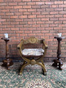 Spanish Carved Oak Cross Frame Hall Chair In Charles II Manor Circa 1890. Circa - 1890 Composition- Solid Oak Exceptional Heavily Carved Hall Chair With Coat Of Arms Back Rest, Sweeping Arm Rests With Arched X Frame Support Stretchers. Beautiful Webbed Seat In Wool Work Tapestry Depicting King & Queen In Floral Landscape With Braided Edge. Stunning Original Patina. A Solid Chair With Exceptional Comfort And Style. Collector Piece. Provenance Purchased In Madrid Collector Sale, Now Part Of Lord Hill Museum Private Collection. Dimensions In Inches Back Height 29” Arm Rest Height 24” Seat Height 17” Back Rest Width 24.7” Depth 18.5”