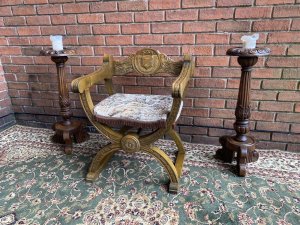 Spanish Carved Oak Cross Frame Hall Chair In Charles II Manor Circa 1890. Circa - 1890 Composition- Solid Oak Exceptional Heavily Carved Hall Chair With Coat Of Arms Back Rest, Sweeping Arm Rests With Arched X Frame Support Stretchers. Beautiful Webbed Seat In Wool Work Tapestry Depicting King & Queen In Floral Landscape With Braided Edge. Stunning Original Patina. A Solid Chair With Exceptional Comfort And Style. Collector Piece. Provenance Purchased In Madrid Collector Sale, Now Part Of Lord Hill Museum Private Collection. Dimensions In Inches Back Height 29” Arm Rest Height 24” Seat Height 17” Back Rest Width 24.7” Depth 18.5”
