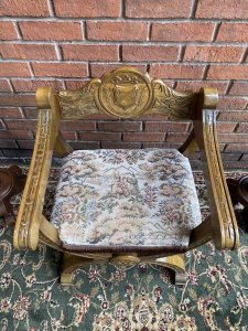 Spanish Carved Oak Cross Frame Hall Chair In Charles II Manor Circa 1890. Circa - 1890 Composition- Solid Oak Exceptional Heavily Carved Hall Chair With Coat Of Arms Back Rest, Sweeping Arm Rests With Arched X Frame Support Stretchers. Beautiful Webbed Seat In Wool Work Tapestry Depicting King & Queen In Floral Landscape With Braided Edge. Stunning Original Patina. A Solid Chair With Exceptional Comfort And Style. Collector Piece. Provenance Purchased In Madrid Collector Sale, Now Part Of Lord Hill Museum Private Collection. Dimensions In Inches Back Height 29” Arm Rest Height 24” Seat Height 17” Back Rest Width 24.7” Depth 18.5”