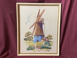 Stunning Vintage Windmill Hand Embroidered Silk Artwork Set In Glazed Frame. Circa- Vintage 1890 Composition- Hand Embroidered Silk Thread Artwork Condition - Lovely Vintage Original Beautifully Quaint And Detailed Composition Of A Large Windmill Set In Rich Flora & Forma Landscape. Rich Blue Rendered Windmill With Half Wooden Cladding Leading Up To Giant Turbines. Picturesque Details Of Wooden Door And Small Windows With Lovely Cottage Style Picket Fence & Planted Garden. Stunning Richly Coloured Composition Created Out Of Many Embroidery Stitches Which Include Straight / Back Stitch, French Knots And Running Stitches. Beautiful Example Of A Hand Embroidered Artwork Set In Glazed Wooden Frame. Dimensions In Inches Height 21.5” Width 17.5”