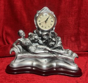 Art Nouveau Style Chaselong Posed Flapper Mantle Clock Working Order Composition - Resin Listing Description Figural Mantle Clock In Art Nouveau Style, Female Posed Relaxing Upon Ornate Chaise-long. Clock Face Set Central Of Figurine, Upon Acanthus Leaf Decoration. Wonderfully Ornate Timepiece. Quartz Movement Battery Powered, In Working Order. Lovely Condition. Dimensions In Cms Height 27cm X Width 32cm X Depth 15cm