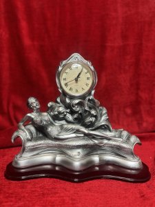 Art Nouveau Style Chaselong Posed Flapper Mantle Clock Working Order Composition - Resin Listing Description Figural Mantle Clock In Art Nouveau Style, Female Posed Relaxing Upon Ornate Chaise-long. Clock Face Set Central Of Figurine, Upon Acanthus Leaf Decoration. Wonderfully Ornate Timepiece. Quartz Movement Battery Powered, In Working Order. Lovely Condition. Dimensions In Cms Height 27cm X Width 32cm X Depth 15cm