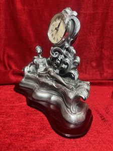 Art Nouveau Style Chaselong Posed Flapper Mantle Clock Working Order Composition - Resin Listing Description Figural Mantle Clock In Art Nouveau Style, Female Posed Relaxing Upon Ornate Chaise-long. Clock Face Set Central Of Figurine, Upon Acanthus Leaf Decoration. Wonderfully Ornate Timepiece. Quartz Movement Battery Powered, In Working Order. Lovely Condition. Dimensions In Cms Height 27cm X Width 32cm X Depth 15cm