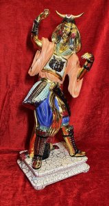 Italian Venetian Bassano Japanese Samurai Warrior Showpiece Circa - 20th Century Composition - Porcelain Brief History Of Bassano Ceramics Nove Bassano Artistic Ceramics Is The Most Famous Of Brands. The Ancient Factory In The Centre Of Nove, A Small Venetian Town On The Right Bank Of The River Brenta, 7 Kilometres From Bassano Del Grappa Stands The Old Factory Of Artistic Ceramics. The Town Of Love Is Internationally Known For Its Artistic Manufacturing Of Italian Ceramics. Dating Back To 1685 A Document Speaks Of Giovanni Bassista Antonibon, A Ceramicist And His Family Had Started The Production Of Majolica In Collaboration With Francesco Parolin. It Is These Familys Whom Carry Out The Tradition Of Quality Italian Ceramics Today. Countless Ceramics Produced In This Factory Are One Show Today In Museums, Embassies, Royal Houses And Private Collections. Listing Description Large Sculptural Showpiece Of Japanese Samurai Warrior With Metallic Gold Gilded Distinctive Japanese Facial Features And Limbs. Large Horned Kaboto Helmet Sits Upon The Warriors Head With Ornamental Earrings. Both Posed Hands Would Of Originally Been Baring A Samurai Sword. Oversized Peach Kimono Tunic With Central Horned Animal Head Motif, Vibrant Blue Pantaloon Trouser With Over Skirt And Samurai Holster. High Gilt Padded Front Boots. Set Upon Marbleised Plinth Base And Stamped On Base By Maker BASSANO. Rare Collectors Figurative Samurai Warrior Museum Grade Showpiece. Condition - Excellent Showing Minor Damage To Helmet Please See Pictures And Samurai Sword Missing. Minor Faults Conducive To Age Of Showpiece. Dimensions In Inches Height 26" Base Width 10.5" X Depth 9"
