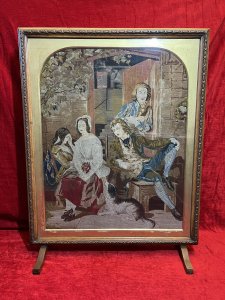 Period Oak Firescreen With Georgian Family Portrait Silkwork Tapestry Sampler Circa - 1830 Composition - Oak Frame/ Silk Work Needle Point Tapestry Listing Description Elegant Egg And Dart Carved Oak Framed Rectangular Fire Screen With Glazed Central Viewing Window With Silk Work Needle Point Tapestry. Tapestry Showcasing Georgian Family Portrait Scene Outside The Doorway Of Their Home With Four Figures Two Female & Two Male. Left Female (In Gold Gown) Sits With Hand Resting Against Her Head, Her Mother Sits Next To Her With Sheep Dog Waiting, A Young Male Leans Back Into His Chair Gazing At The Female Whilst Male Behind Him Stares Toward The Viewer. Lovely Details With Stonework And Ornate Country Oak Door With View Of Interior Through The Doorway. Stands Upon Slender Feet. Beautiful Quality Artwork For Room Display Or Use As Fire Cover When Not In Use. Dimensions In Inches Height 34" X Width 26.5" X Depth 9 3/4" (at base)