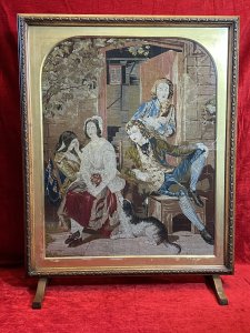 Period Oak Firescreen With Georgian Family Portrait Silkwork Tapestry Sampler Circa - 1830 Composition - Oak Frame/ Silk Work Needle Point Tapestry Listing Description Elegant Egg And Dart Carved Oak Framed Rectangular Fire Screen With Glazed Central Viewing Window With Silk Work Needle Point Tapestry. Tapestry Showcasing Georgian Family Portrait Scene Outside The Doorway Of Their Home With Four Figures Two Female & Two Male. Left Female (In Gold Gown) Sits With Hand Resting Against Her Head, Her Mother Sits Next To Her With Sheep Dog Waiting, A Young Male Leans Back Into His Chair Gazing At The Female Whilst Male Behind Him Stares Toward The Viewer. Lovely Details With Stonework And Ornate Country Oak Door With View Of Interior Through The Doorway. Stands Upon Slender Feet. Beautiful Quality Artwork For Room Display Or Use As Fire Cover When Not In Use. Dimensions In Inches Height 34" X Width 26.5" X Depth 9 3/4" (at base)