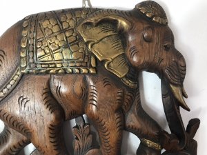 Large Hand Carved Plaque Of Balancing Trio Of Elephants In Hardwood & Gilt Work. Three Elephants Beautifully Carved With Delicate Flowers And Acanthus Vines Stand On Top Of One Another. Large Gilt Sunflower Motif As Base With Gilt Saddle Mats, Tusks, Ears And Anklets. Stunning Decorative Piece Dimensions In Inches Height 35” Width 14” Depth 1 1/4”
