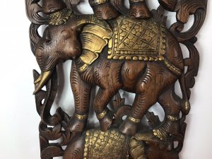 Large Hand Carved Plaque Of Balancing Trio Of Elephants In Hardwood & Gilt Work. Three Elephants Beautifully Carved With Delicate Flowers And Acanthus Vines Stand On Top Of One Another. Large Gilt Sunflower Motif As Base With Gilt Saddle Mats, Tusks, Ears And Anklets. Stunning Decorative Piece Dimensions In Inches Height 35” Width 14” Depth 1 1/4”