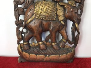 Large Hand Carved Plaque Of Balancing Trio Of Elephants In Hardwood & Gilt Work. Three Elephants Beautifully Carved With Delicate Flowers And Acanthus Vines Stand On Top Of One Another. Large Gilt Sunflower Motif As Base With Gilt Saddle Mats, Tusks, Ears And Anklets. Stunning Decorative Piece Dimensions In Inches Height 35” Width 14” Depth 1 1/4”