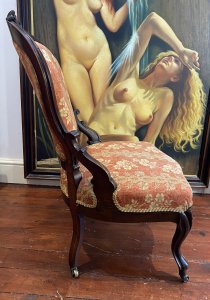 Ladies French Empire Sewing Chair With Elegant Floral Upholstery. Antique Sewing Chair With Carved Solid Walnut Frame. Padded Harp Shaped Back Rest With Cartouche Crest Top Pinnacle And Highly Elaborate Scroll Supports. Sprung Shaped Seat. Stands Upon Cabriole Scrolled Front And Splayed Back Legs Over Solid Brass Castors For Ease Of Movement. Exceptional Example Of Genuine Antique Chair Dated 1870 Sewing Chair. Stunning Original Patina And Condition With Wear Marks On The Woodwork Due To Age. Upholstery In Pristine Condition. Delicate Floral Upholstery In Rosey Peach Colour With Symmetrical Floral Spray Pattern. Edged In Light Gold Gimp Braid. Craftsman Made. Exceptional Comfort. Stunning Highly Decorative Ladies Chair For Boudoir Or Lounge. Dimensions In Inches Back Height 38.5” Width 22” Depth 21” Seat Height 16”
