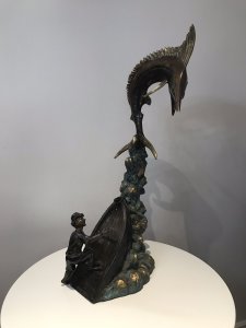 Vintage 20th Century Quality Bronze Statue Merlin Fish & Fishing Boat Capsized With Gilded Rock Supporting The Elaborate Merlin Fish On The Top Showpiece Excellent Detail To The Sculpture Fisherman’s Face Impeccably Executed Wonderful Collectors Rare Statement Antique Look Bronze Statue Signed By Artist On Side Of Fishing Boat Weight Approx 15Kg Dimension In Inches Height 34” Width 15” Depth 11”