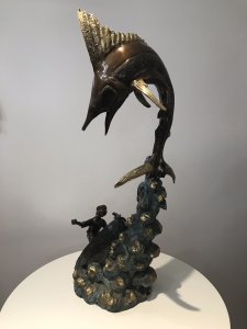 Vintage 20th Century Quality Bronze Statue Merlin Fish & Fishing Boat Capsized With Gilded Rock Supporting The Elaborate Merlin Fish On The Top Showpiece Excellent Detail To The Sculpture Fisherman’s Face Impeccably Executed Wonderful Collectors Rare Statement Antique Look Bronze Statue Signed By Artist On Side Of Fishing Boat Weight Approx 15Kg Dimension In Inches Height 34” Width 15” Depth 11”