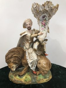 Museum Grade Sultan And Lion Cornucopia Minton Ornamental Vase. Important Minton Statue Sultan Holding Cornucopia Vase Sitting Upon A Roaring Lion Set On Decorative Mound Of Earth Stunning Cornucopia Vase Decorated With Roses And Bouquet Of Bronze Leaves Profusely Gilded Richly Dressed Gilded Sultan With Lifelike Face Tasseled Cape And Pointed Shoes Sitting Roaring Lion With Impeccable Detail Is A Wonderful Creative Subject Vibrant Colours Absolutely Stunning Decorative Museum Piece Two Finger Ends Missing On The Sultan Conducive To Age Of The Piece Otherwise In Perfect Condition Purchased From Earl Of Germans Collection 1930’s A Historic Object Of Virtue Dimensions In Inches Height 19.5” Width 12.5” Base Depth 7.5”