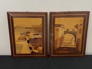 Pair Of Italian Landscapes Fruitwood Inlaid Sorrento Plaques. Circa - Vintage Composition- Fruitwood . Rosewood, Calamander Wood, Satinwood Inlays A Stunning Pair Of Hand Crafted Sorrento Parquetry Plaques Displaying Italian Landscapes. Hanging Hooks On The Back For Wall Display. First Plaque Italian Sea Scape With Mountainous Background And Headland. A Forest Area With Houses In The Foreground All Beautifully Hand Inlaid In Precious Fruit Woods. Rosewood Frame With Satinwood Boarder. Second Plaque Italian Village Scene With Ornamental Bridge And Walk Way Through Idyllic Houses. Stunning Details Of Arched Doorway, Bridge Foliage And Mountains In The Distance. Set In Rosewood Frame With Satinwood Border. Dimensions In Inches Height 9” Width 6 3/4”