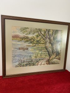 Hand Woven Lake Windermere Landscape Tapestry With Fisherman In Rowing Boat Circa - 20th Century Vintage Composition - Wool Work Intricate Woodwork Tapestry With Stunning Lake View Showing Fisherman Patiently Sitting In A Rowing Boat With His Fishing Rod Perched. The Lake Surrounded By Reeds, Lilly Pads And Water Daisies With Narrow Track To The Right With Detailed Trees And Jetty. Lovely Charming Subject With Stunning Perspective In A Array Of Vibrant Yellow, Green, And Blue Hues. Lake Scene Thought To Be At Lake Windermere. Framed / Unsigned Dimension In Inches Height 25.5" Width 31 1/4"