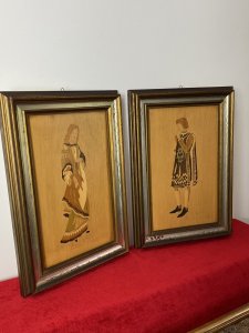 Pair Of Italian Renaissance Early Medieval Noble Figures In Costume Marquetry Plaques Circa - Vintage Composition - Marquetry Inlay In Exotic Woods Beautiful Delicately Hand Inlaid Matching Pair Of Male And Female Noble Figures Wearing Early Medieval Costume In Exotic Woods. Bright Satin Wood Backgrounds With Olive Wood, Amboyna Wood And Sandal Wood Inlays. Female Noble Lady Plaque With Long Blonde Hair Wearing Elaborate Tiered Flowing Gown With Detailed Abstract Pattern And Geometric Edging. The Noble Male Plaque With Shoulder Length Hair, Wears Tabard Tunic With Central Noble Crest, White Medieval Tights And Anklet Boots. Both Set In Gilt Wood Frame. Very Desirable Pair, Wall Hanging Hooks On Reverse. Dimensions In Inches Height 19 1/4" Width 13 1\4"