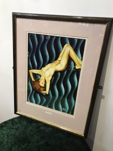 Contemporary Signed Proof 1/200 Titled Wavy Navy Nude Portrait By Malcolm Morris Title - Wavy Navy Artist - Malcolm Morris Signed Lithograph Of Original Contemporary Watercolour Nude Painting By Artist Malcolm Morris Proof Number 1 Of 200 By Renowned Welsh Artist Contemporary Unusual Wavy Background In Vivid Blue Hues With Posed Nude Muse With Fine Detail Very Well Executed Nude Lithograph Portrait Set In Glazed Wooden Frame Dimensions In Inches Height 24” Width 18.5”
