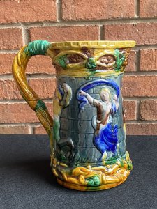 Large Minton Majolica Style Pitcher Jug With Dancing Maidens & Jesters Decoration. Circa - Vintage Reproduction Composition - Glazed Pottery/ Earthenware Beautiful Large Vibrant Glazed Pouring Jug In The Minton Majolica Style. This Design Is Typical Of Minton During The Late 19th Century. A Large Vine Like Structure Makes Up The Shaped Handle Which Entwines The Top & Bottom Edge Of The Jug With Sprays Of Grapes And Leaves. The Central Portion Of The Jug Has Large Relief Figures Of Maidens And Jesters Lavishly Posed Dancing. Very Decorative And Useable Piece. Condition- Used Vintage No Damage Lovely Condition. Dimensions In Cms Height 24.5cms Width 23cms Depth 11.5cms (top)