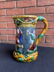 Large Minton Majolica Style Pitcher Jug With Dancing Maidens & Jesters Decoration. Circa - Vintage Reproduction Composition - Glazed Pottery/ Earthenware Beautiful Large Vibrant Glazed Pouring Jug In The Minton Majolica Style. This Design Is Typical Of Minton During The Late 19th Century. A Large Vine Like Structure Makes Up The Shaped Handle Which Entwines The Top & Bottom Edge Of The Jug With Sprays Of Grapes And Leaves. The Central Portion Of The Jug Has Large Relief Figures Of Maidens And Jesters Lavishly Posed Dancing. Very Decorative And Useable Piece. Condition- Used Vintage No Damage Lovely Condition. Dimensions In Cms Height 24.5cms Width 23cms Depth 11.5cms (top)